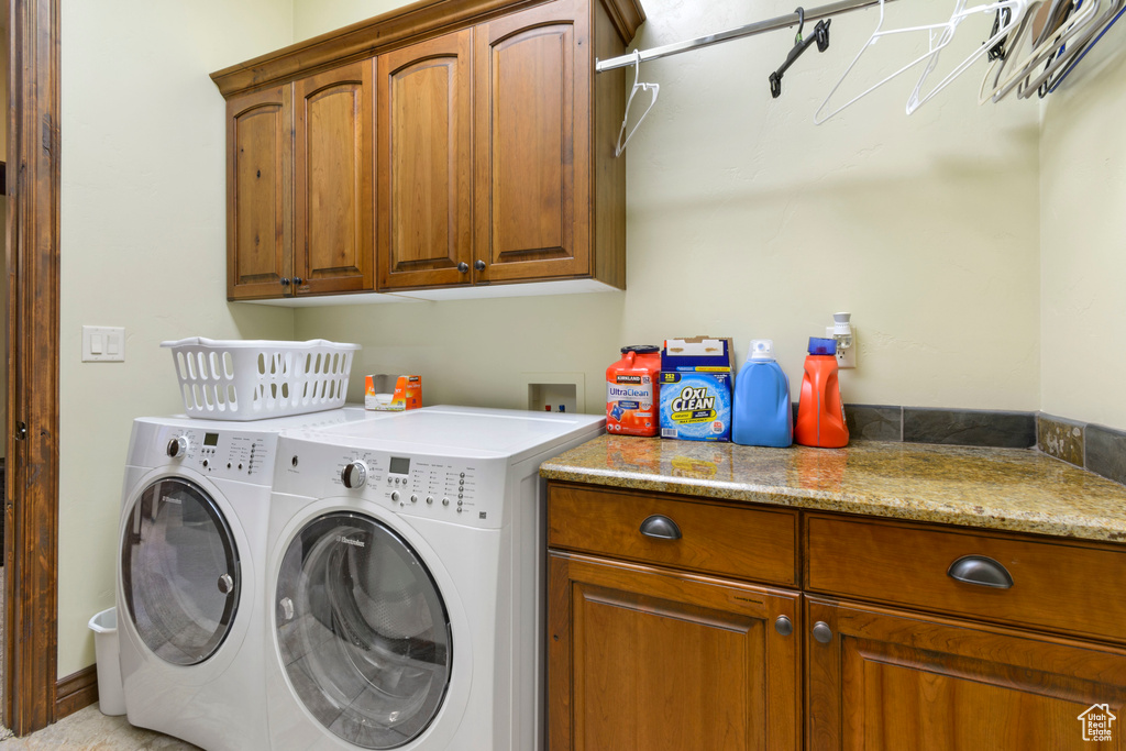 Laundry area featuring cabinets, independent washer and dryer, and hookup for a washing machine