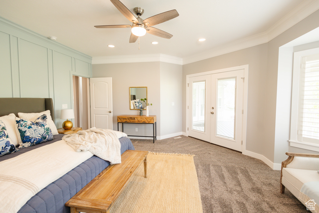 Carpeted bedroom featuring french doors, ceiling fan, access to exterior, and multiple windows