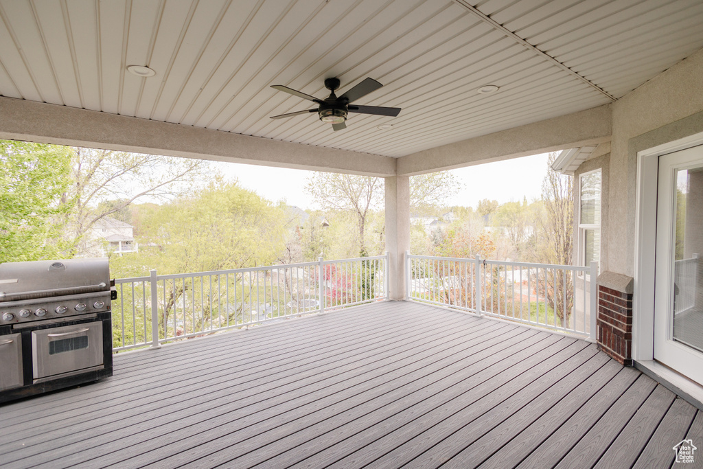Deck featuring a grill and ceiling fan