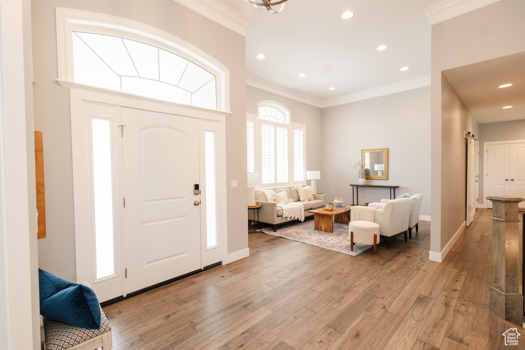 Entryway featuring crown molding and hardwood / wood-style flooring
