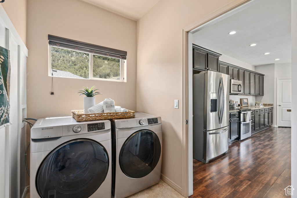 Washroom with dark hardwood / wood-style floors, separate washer and dryer, and hookup for a washing machine