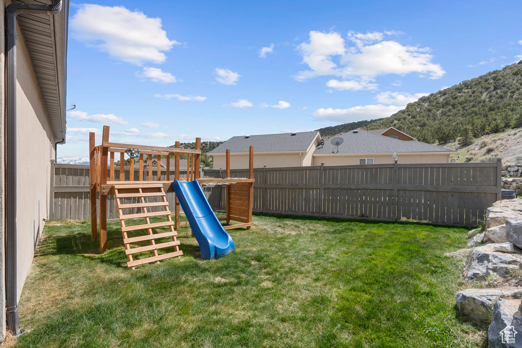 View of yard featuring a playground and a mountain view