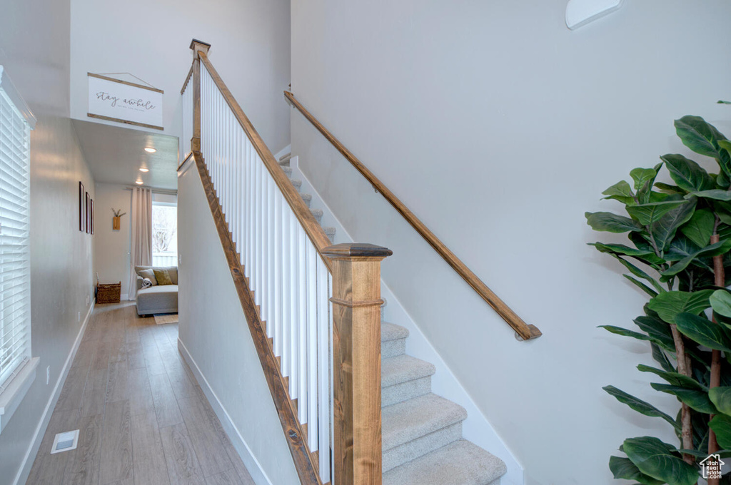 Staircase with hardwood / wood-style flooring