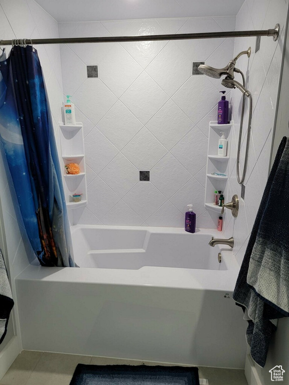 Bathroom featuring shower / bath combo and tile floors