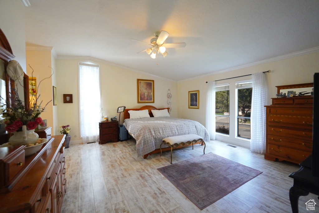 Bedroom with crown molding, light hardwood / wood-style floors, ceiling fan, and access to exterior