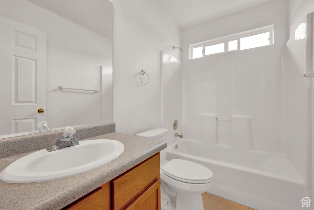 Full bathroom with vanity, shower / bathtub combination, tile floors, and toilet