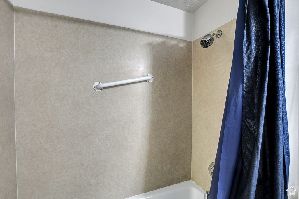 Bathroom featuring shower / bathtub combination with curtain