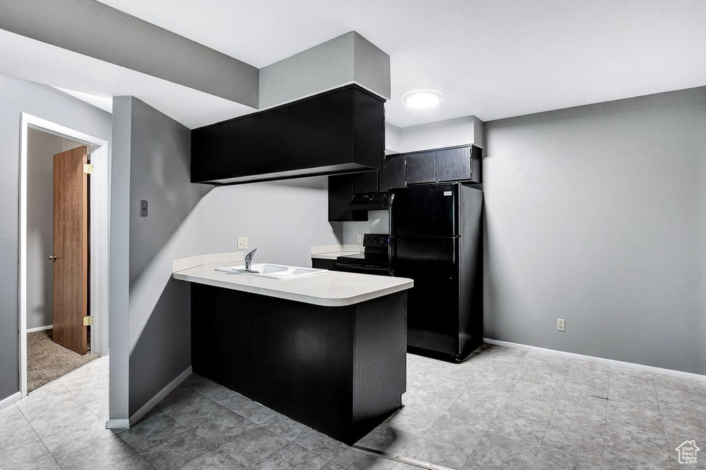 Kitchen featuring light tile floors, sink, black appliances, ventilation hood, and kitchen peninsula