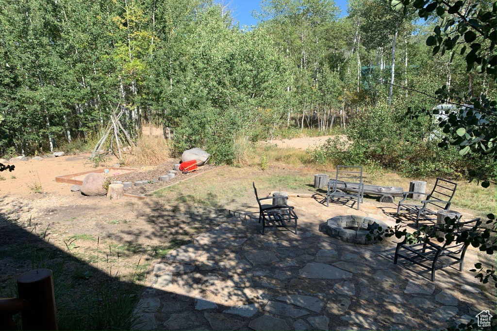 View of yard featuring an outdoor fire pit and a patio area