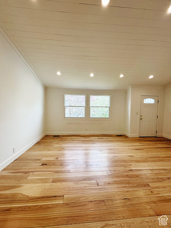 Empty room featuring light hardwood / wood-style floors and ornamental molding