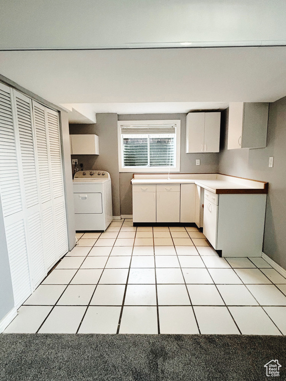 Kitchen featuring light tile flooring and washer / clothes dryer