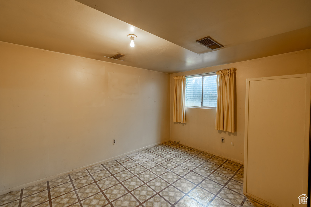 Spare room featuring light tile floors