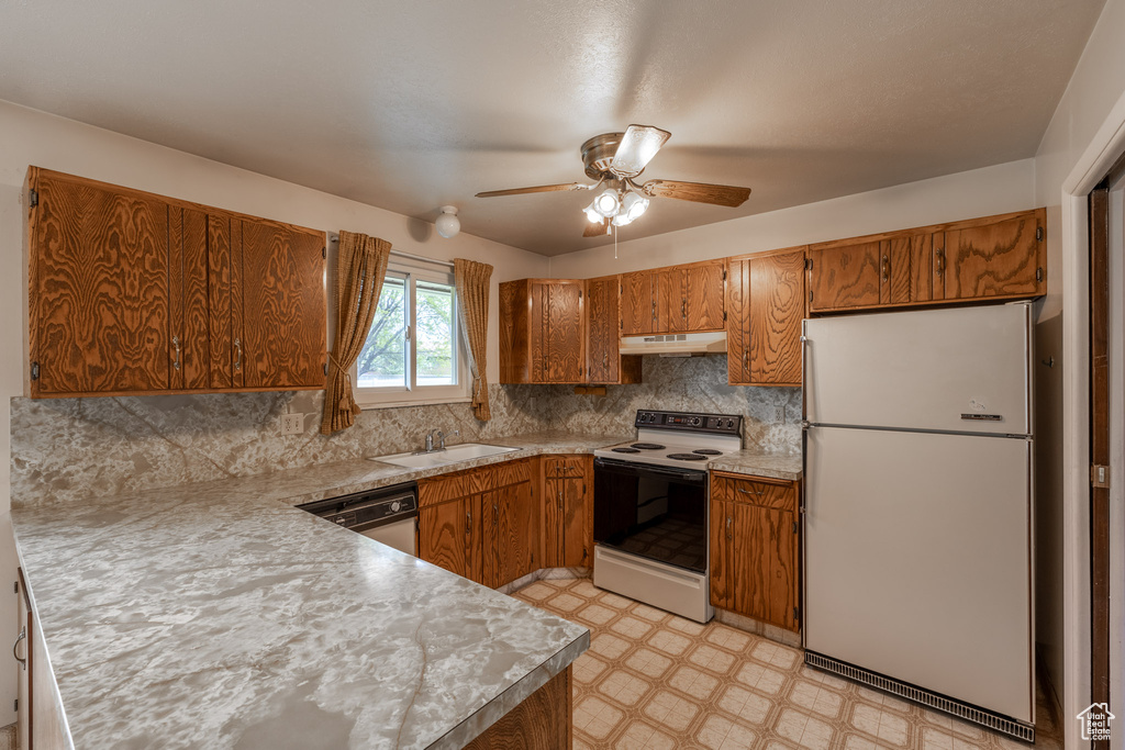 Kitchen with backsplash, white appliances, ceiling fan, sink, and light tile floors