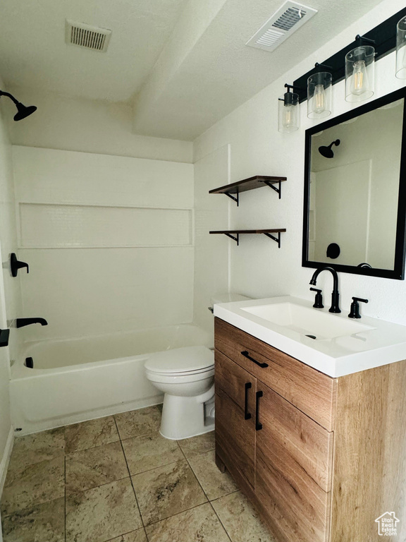 Full bathroom featuring shower / bath combination, toilet, tile floors, and vanity