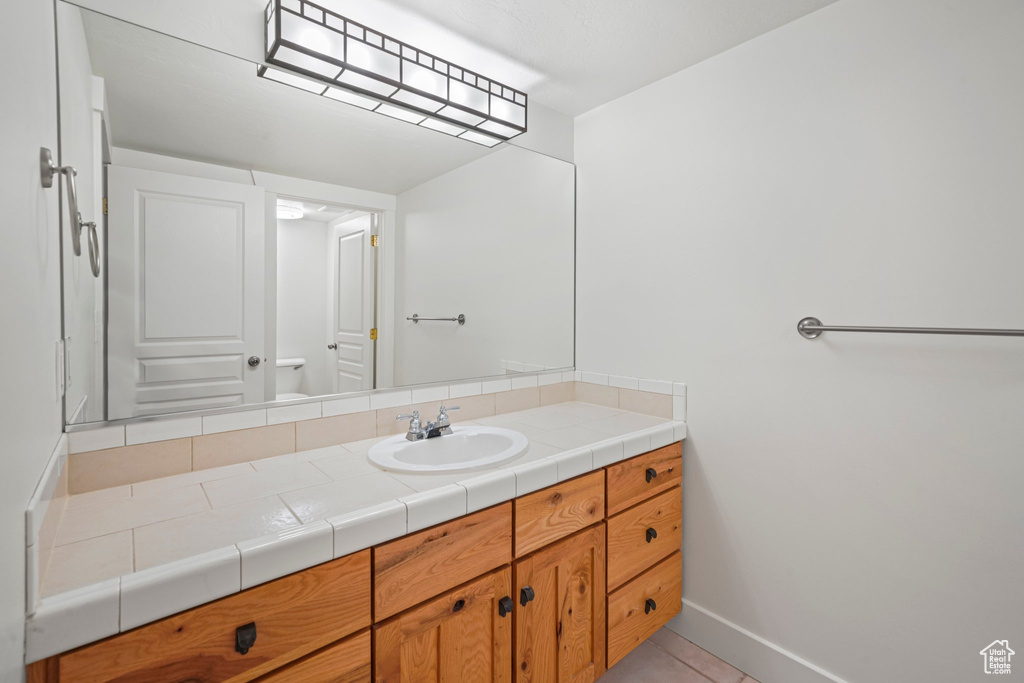 Bathroom featuring tile flooring and vanity