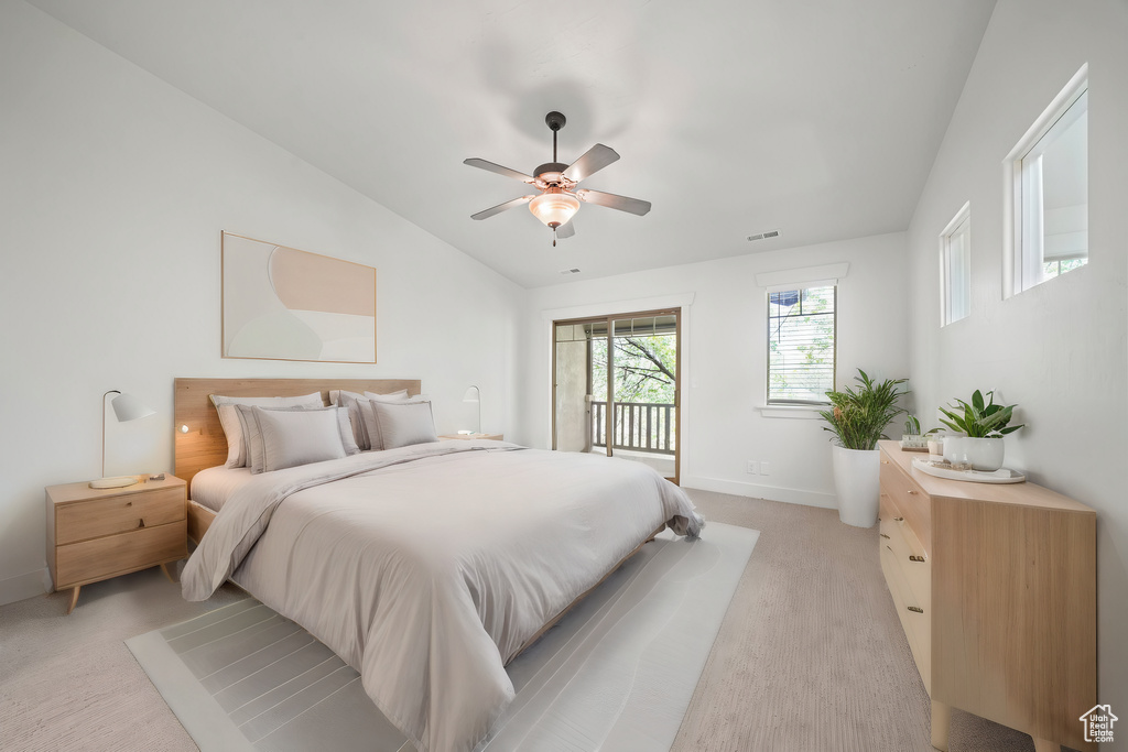 Carpeted bedroom featuring access to outside, ceiling fan, and lofted ceiling