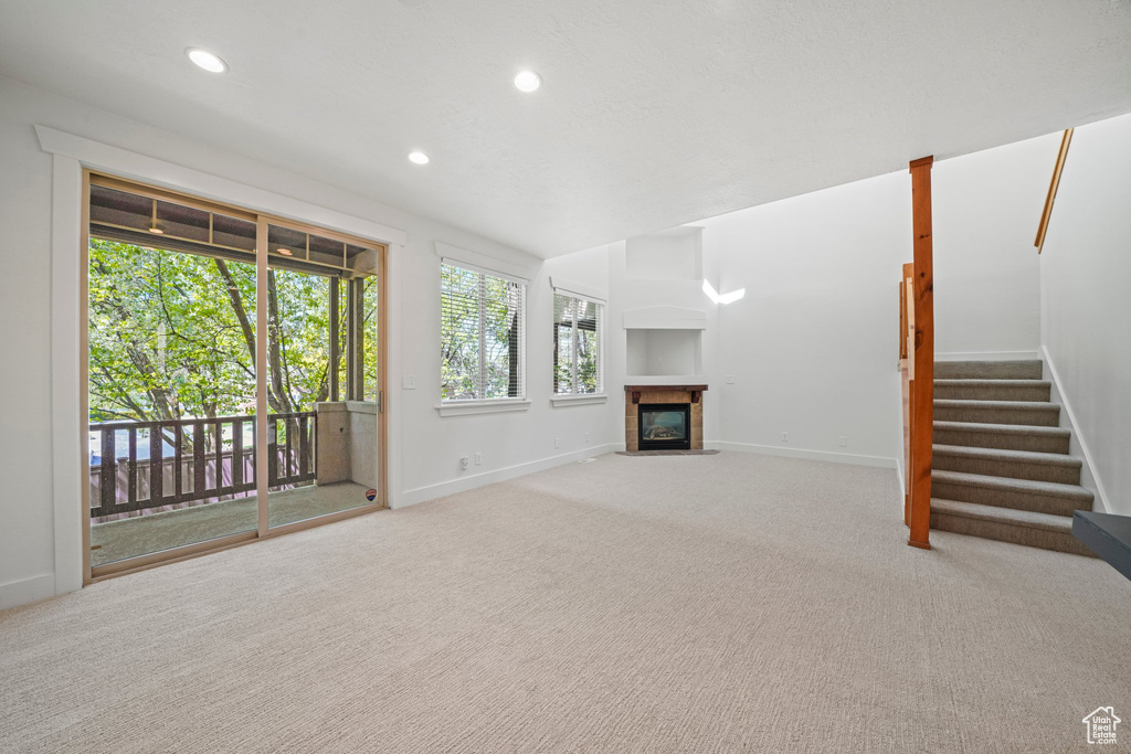 Unfurnished living room featuring carpet flooring