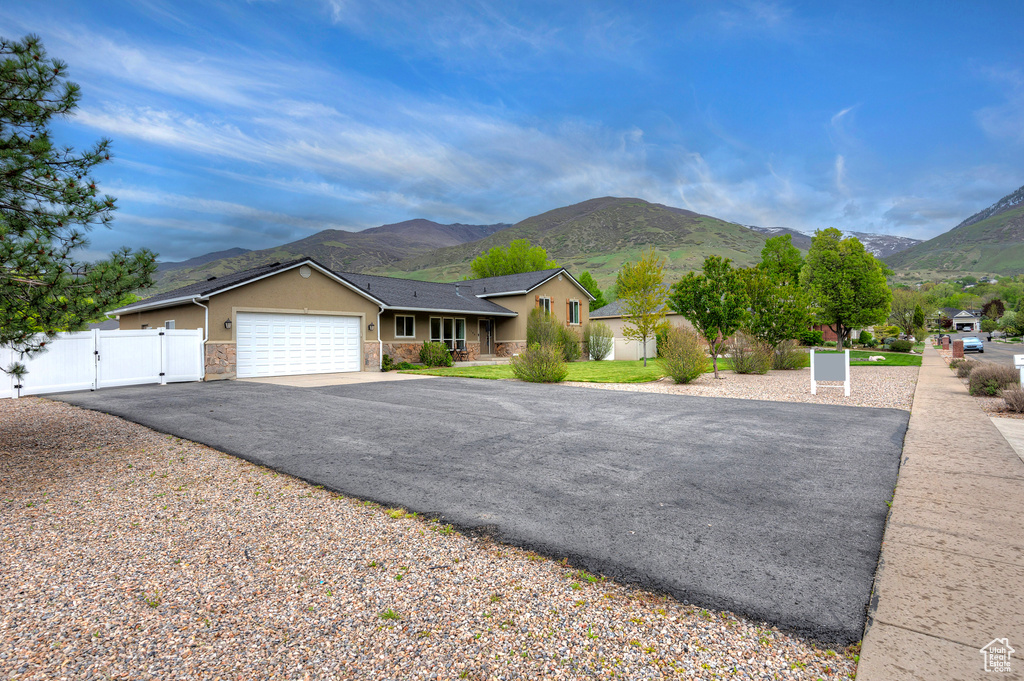 Single story home featuring a mountain view and a garage