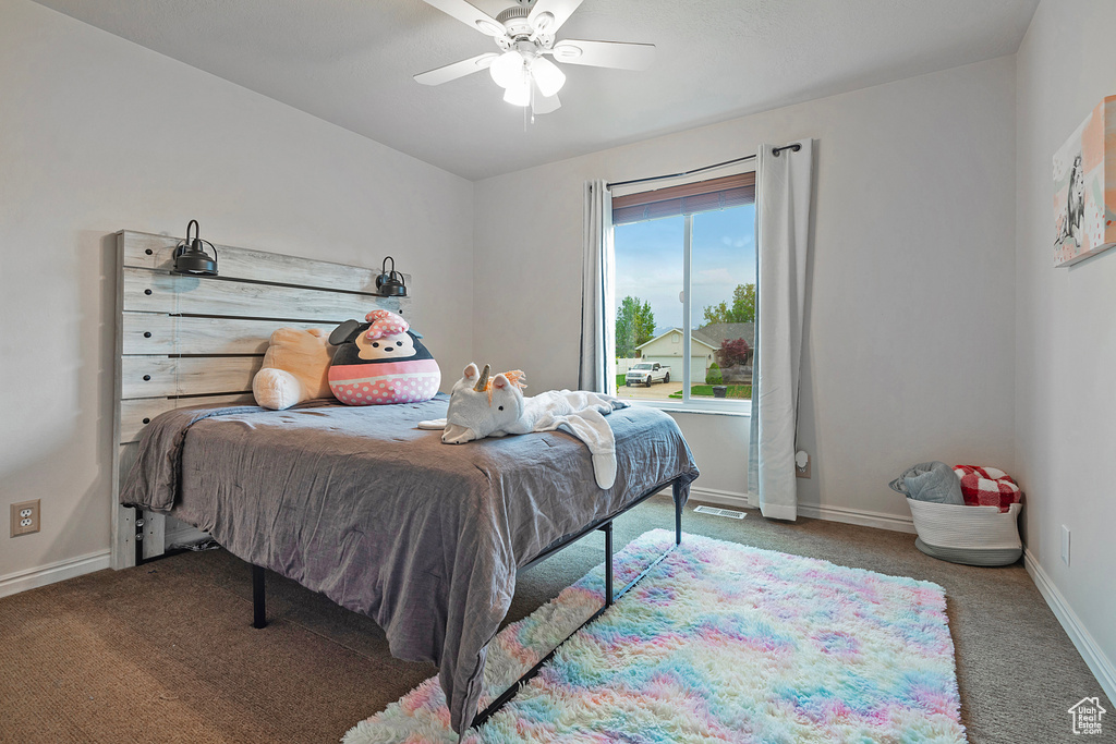 Bedroom featuring ceiling fan and carpet flooring