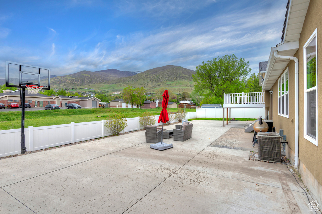 View of terrace with central AC, a mountain view, and an outdoor hangout area