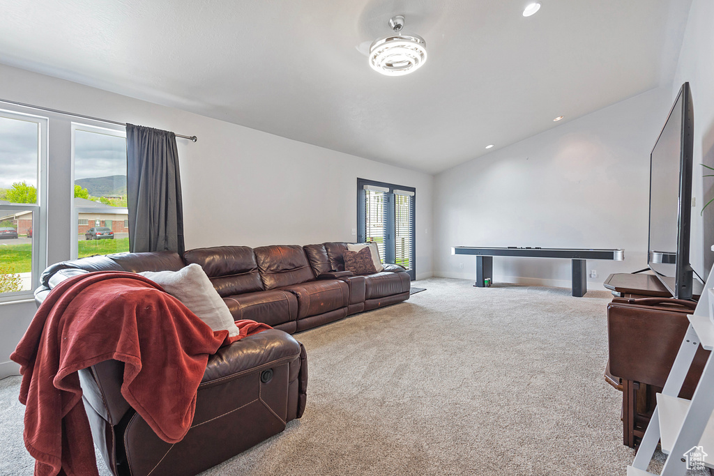 Carpeted living room with vaulted ceiling