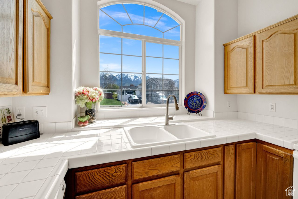 Kitchen featuring tile countertops and sink