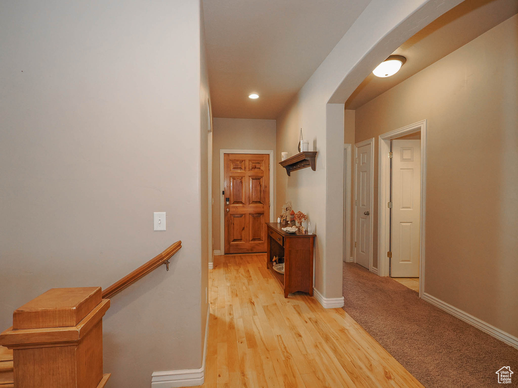 Hallway featuring light carpet