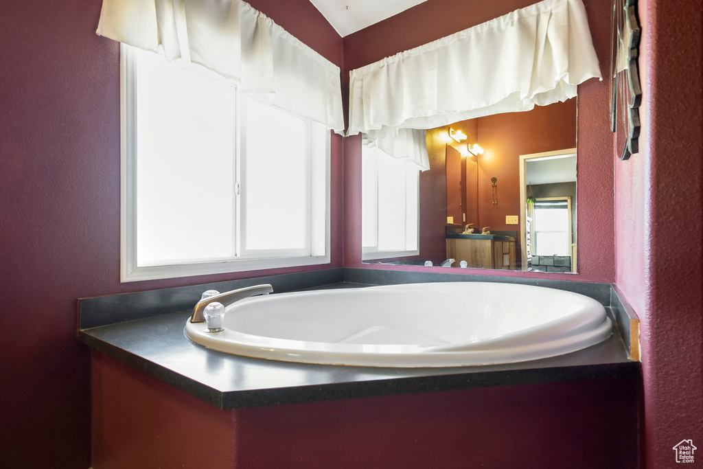 Bathroom with a bath to relax in and vanity