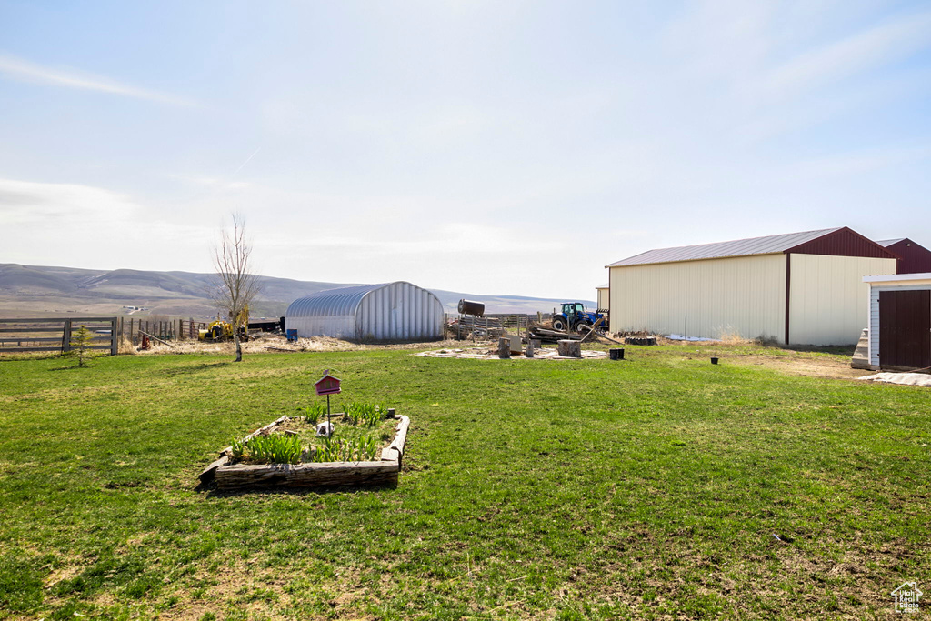 View of yard featuring a mountain view and an outdoor structure