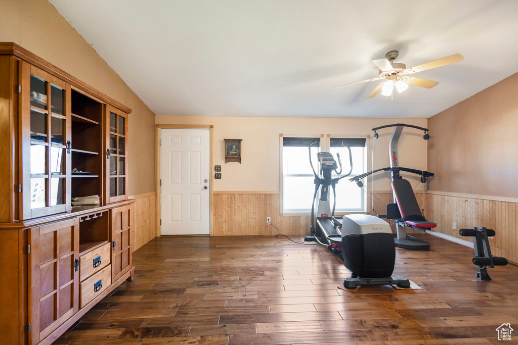 Exercise area with dark wood-type flooring and ceiling fan