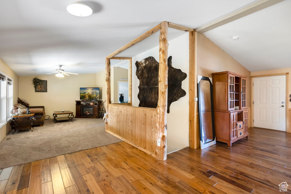 Hall with hardwood / wood-style flooring and vaulted ceiling