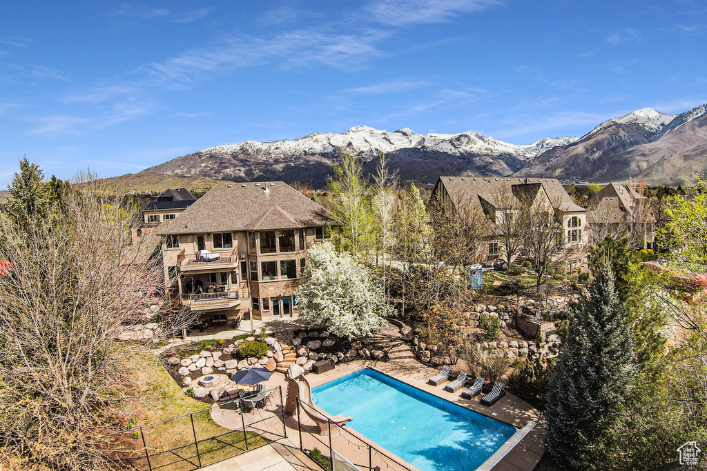 View of pool featuring a patio area and a deck with mountain view