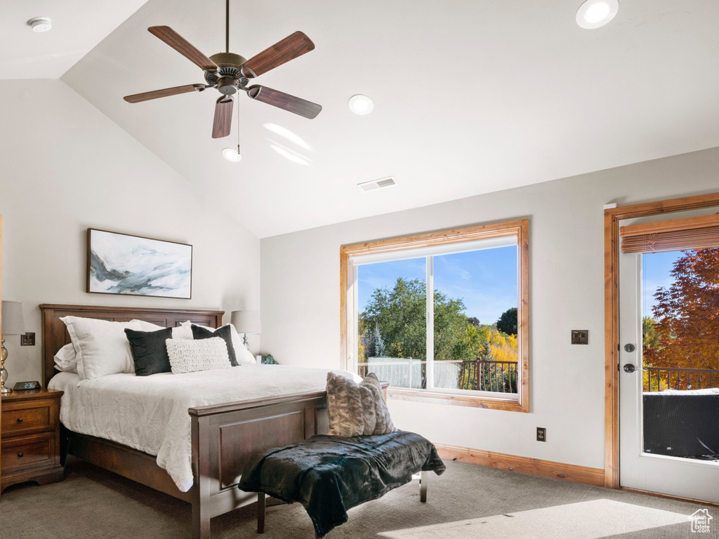 Bedroom with high vaulted ceiling, ceiling fan, carpet flooring, and access to outside
