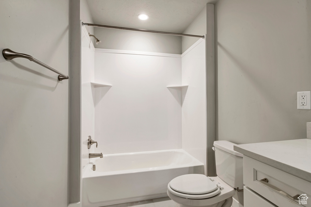 Full bathroom featuring vanity, shower / bathtub combination, and toilet