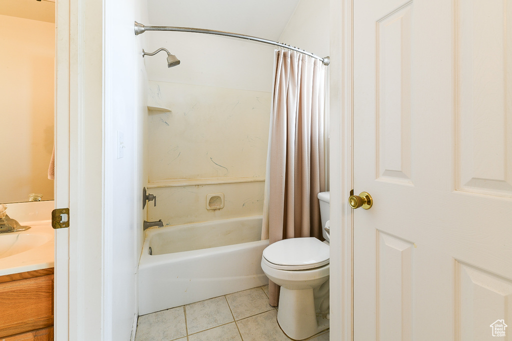 Full bathroom featuring tile flooring, shower / tub combo, vanity, and toilet