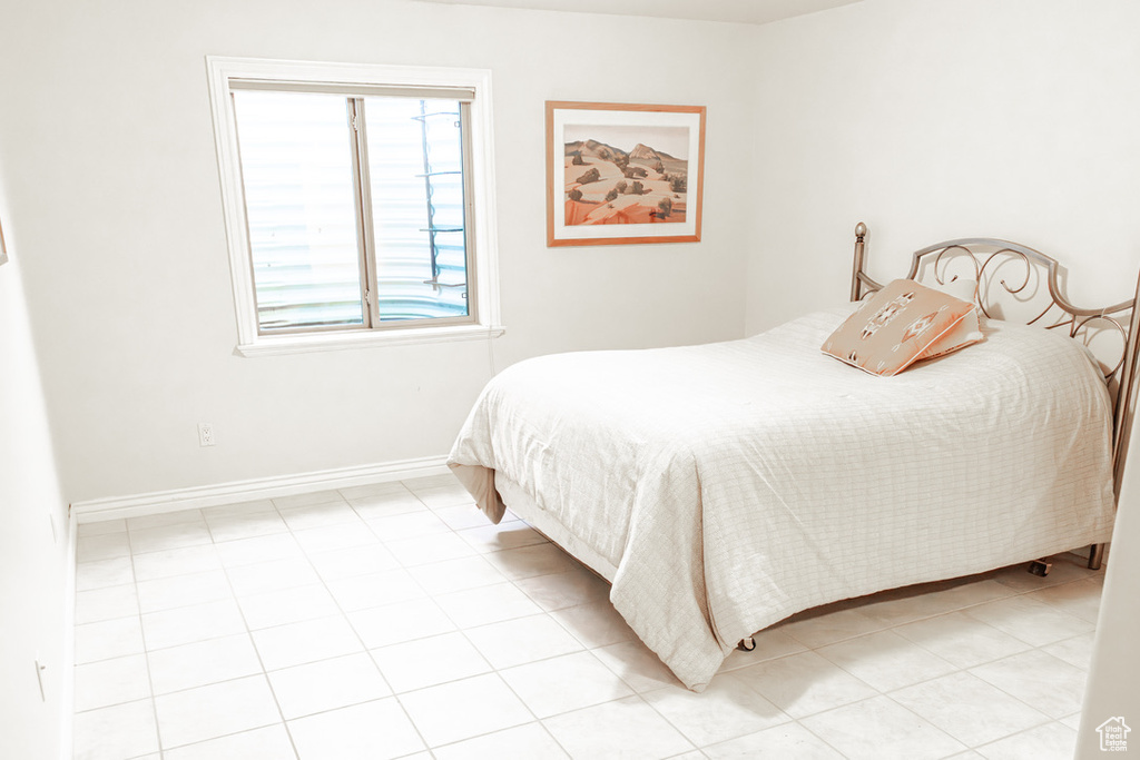 Bedroom featuring light tile floors