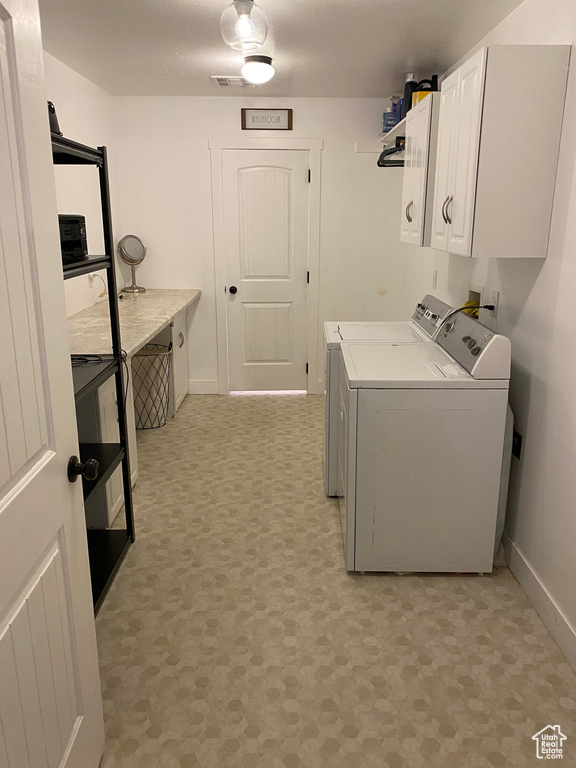 Clothes washing area with cabinets, separate washer and dryer, and hookup for a washing machine
