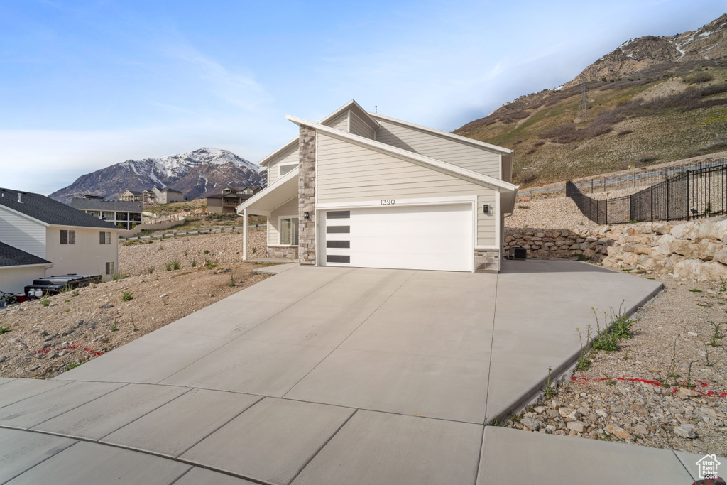 View of front facade featuring a mountain view and a garage