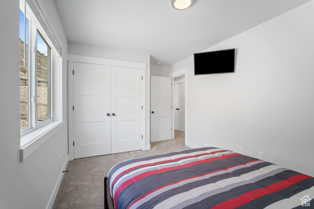 Bedroom featuring a closet and carpet flooring