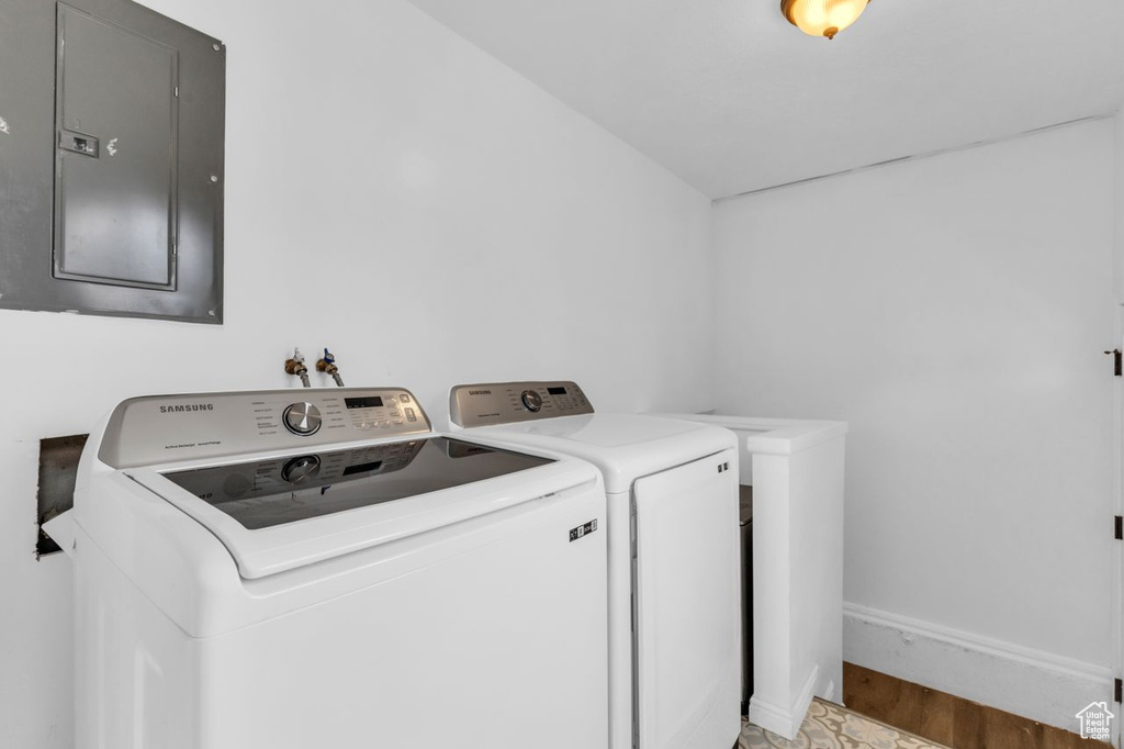 Laundry room with hardwood / wood-style floors, washing machine and dryer, and hookup for a washing machine
