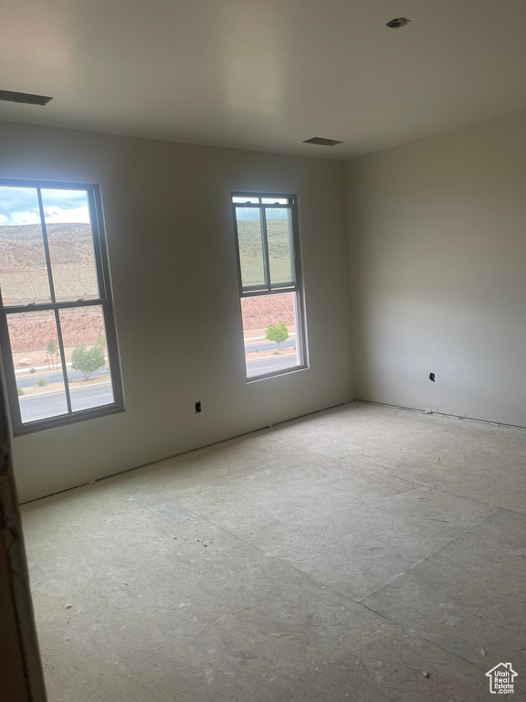 Spare room featuring a wealth of natural light