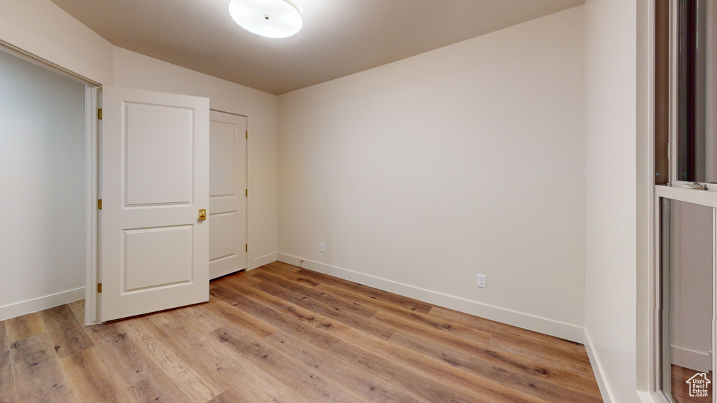 Unfurnished bedroom with light wood-type flooring