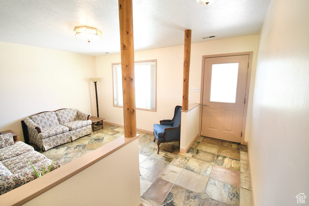 Tiled entrance foyer featuring a textured ceiling