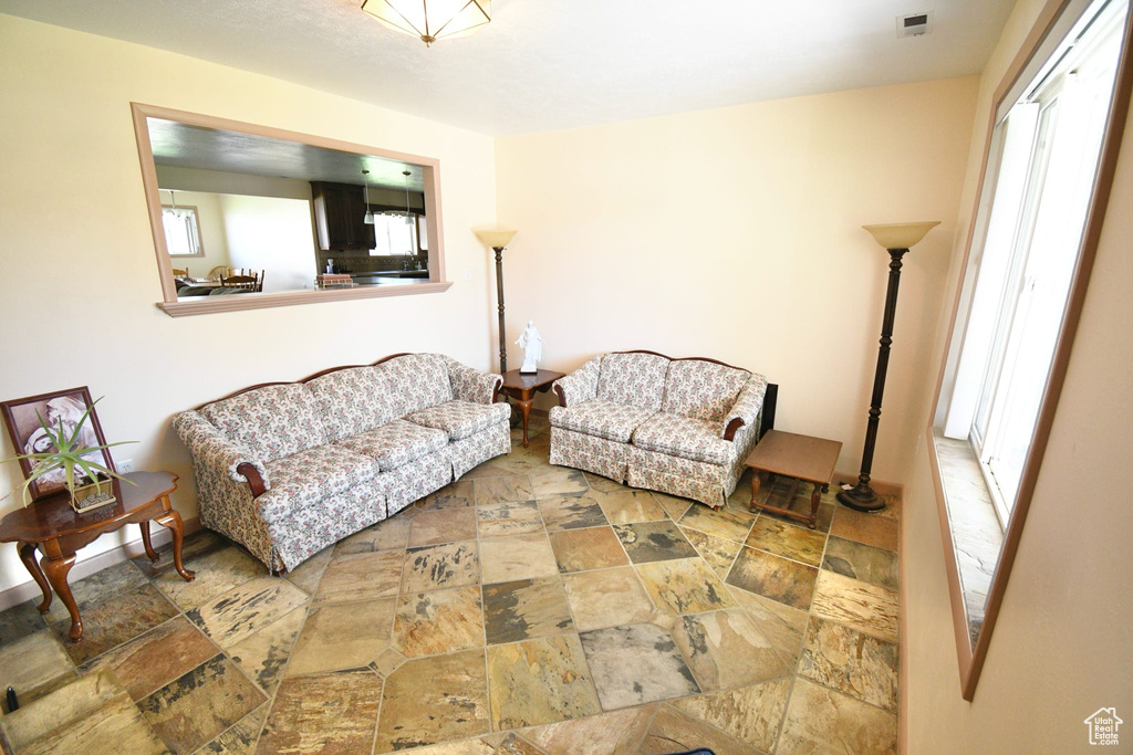 Living room with tile floors and a wealth of natural light