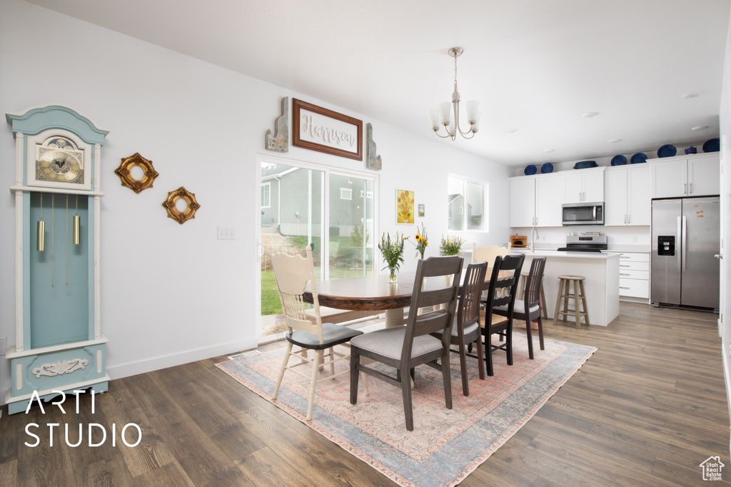 Dining space featuring a chandelier and dark hardwood / wood-style floors