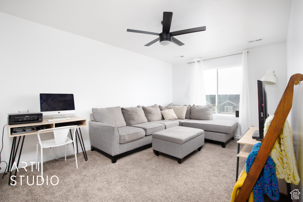 Living room featuring carpet flooring and ceiling fan