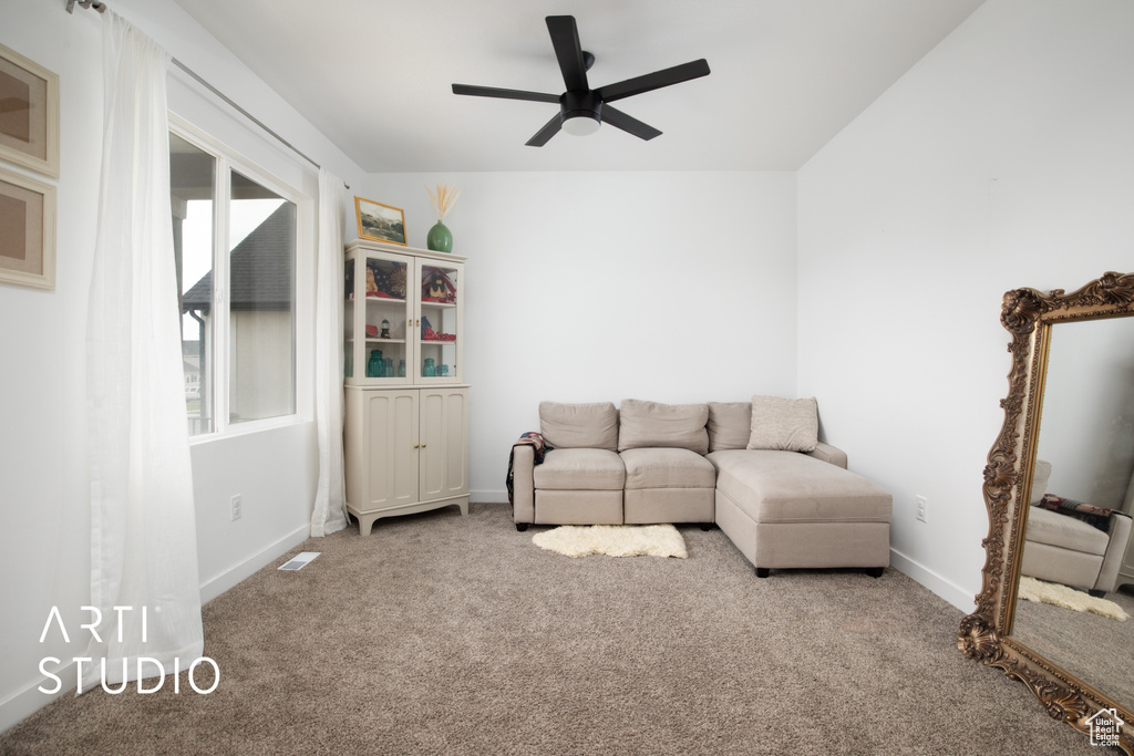 Living room with ceiling fan and carpet