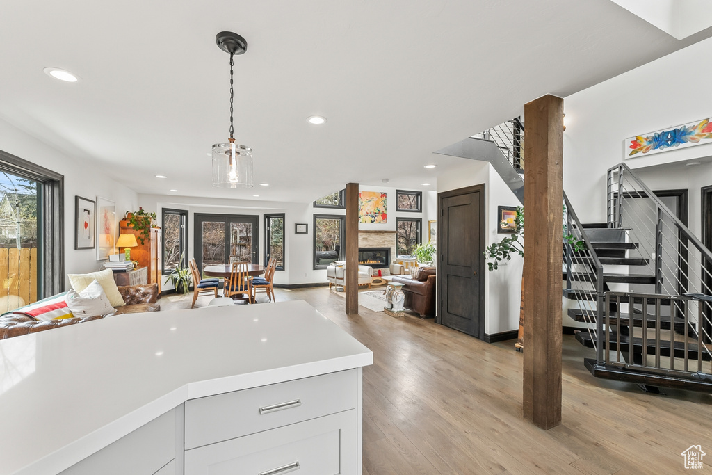 Kitchen featuring light hardwood / wood-style floors and decorative light fixtures