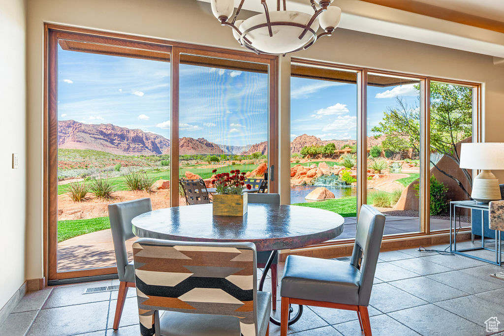 Tiled dining area featuring a mountain view and a chandelier