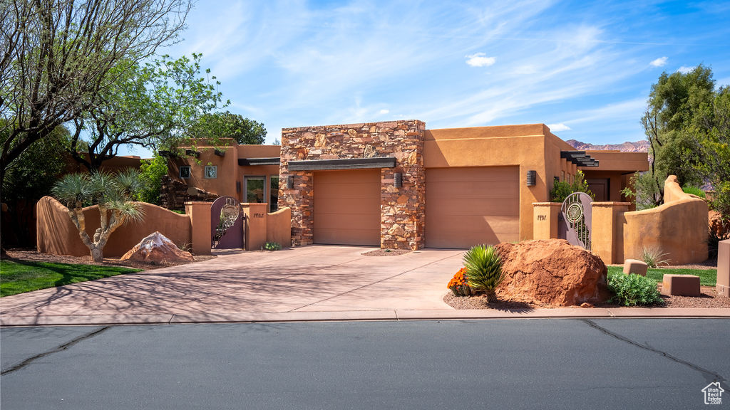Pueblo-style house with a garage